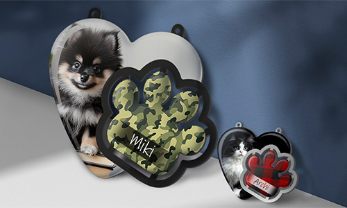 Heart and paw-shaped pet tags with dog and cat photos, labeled “Miki” and “Aria” — custom camouflage and red designs.