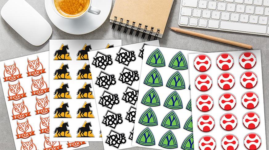 Five sticker sheets with personalized designs — flames, fox, YOU text, triangle emblem, and abstract red symbol.