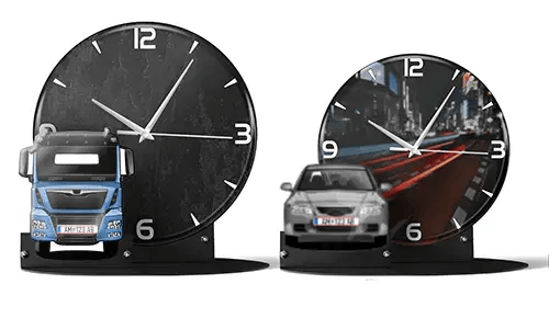 Two decorative clocks with model vehicles: left with black marble face and blue truck, right with cityscape and red sports car