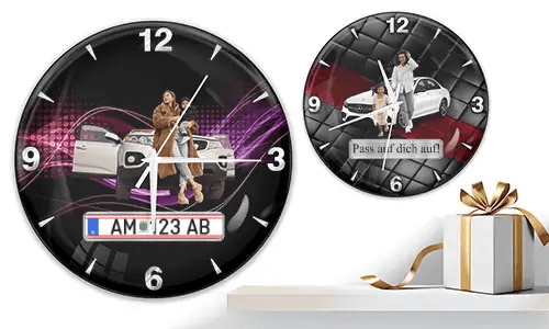 Two wall clocks with family car scenes: left with woman and child at white SUV over purple waves, right with white car and quilted red-black background