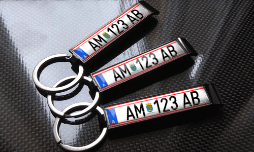 three bottle opener keychains with flags