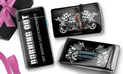 Three glossy cigarette cases with automotive themes. One reads 
