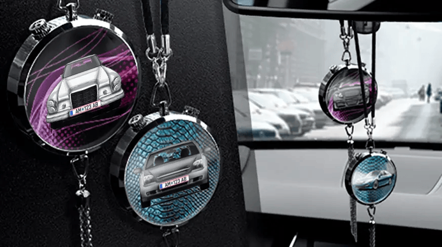 Two circular car air fresheners hanging from rearview mirror: left with black car, right with blue car